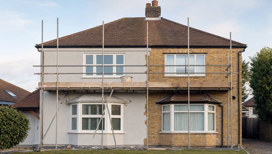 Scaffold lifts along a building elevation for rendering access